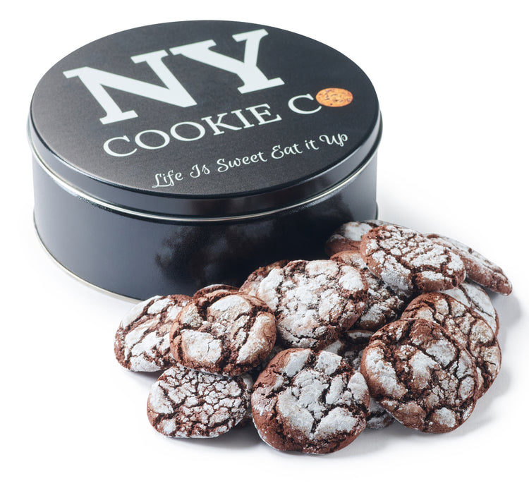 Chocolate Crinkle cookies with a powdered-sugar finish beside the black NY Cookie Co. tin