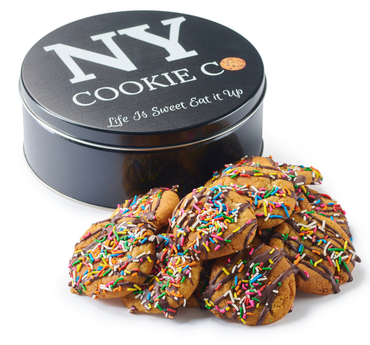 Chocolate Crinkle cookies beside a black NY Cookie Co. tin